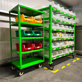 A green 5-tier storage and transport trolley with mobile shelving units, equipped with various colored storage bins.